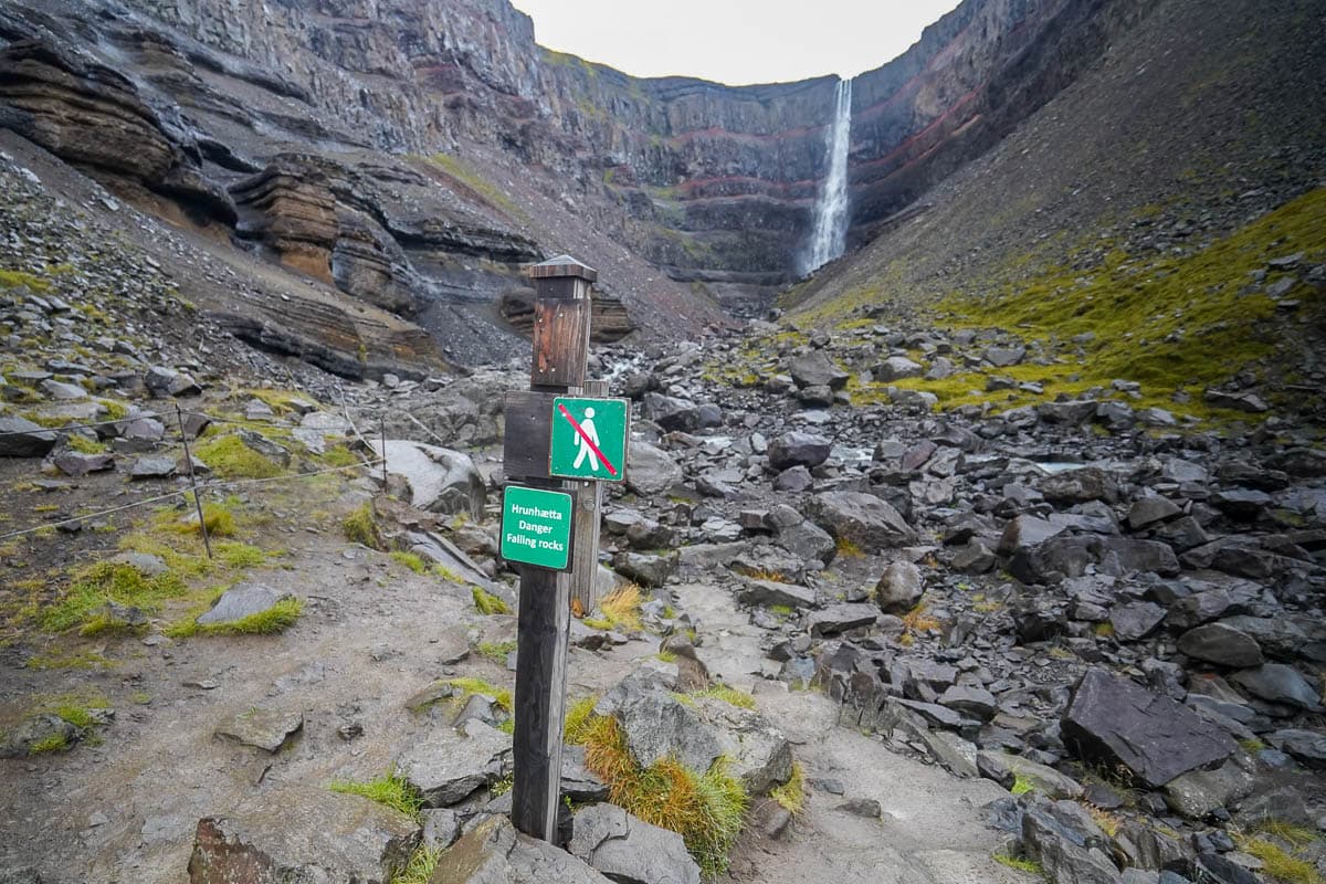 No hiking sign at the end of the Hengifoss hike with the waterfall in the background in Iceland