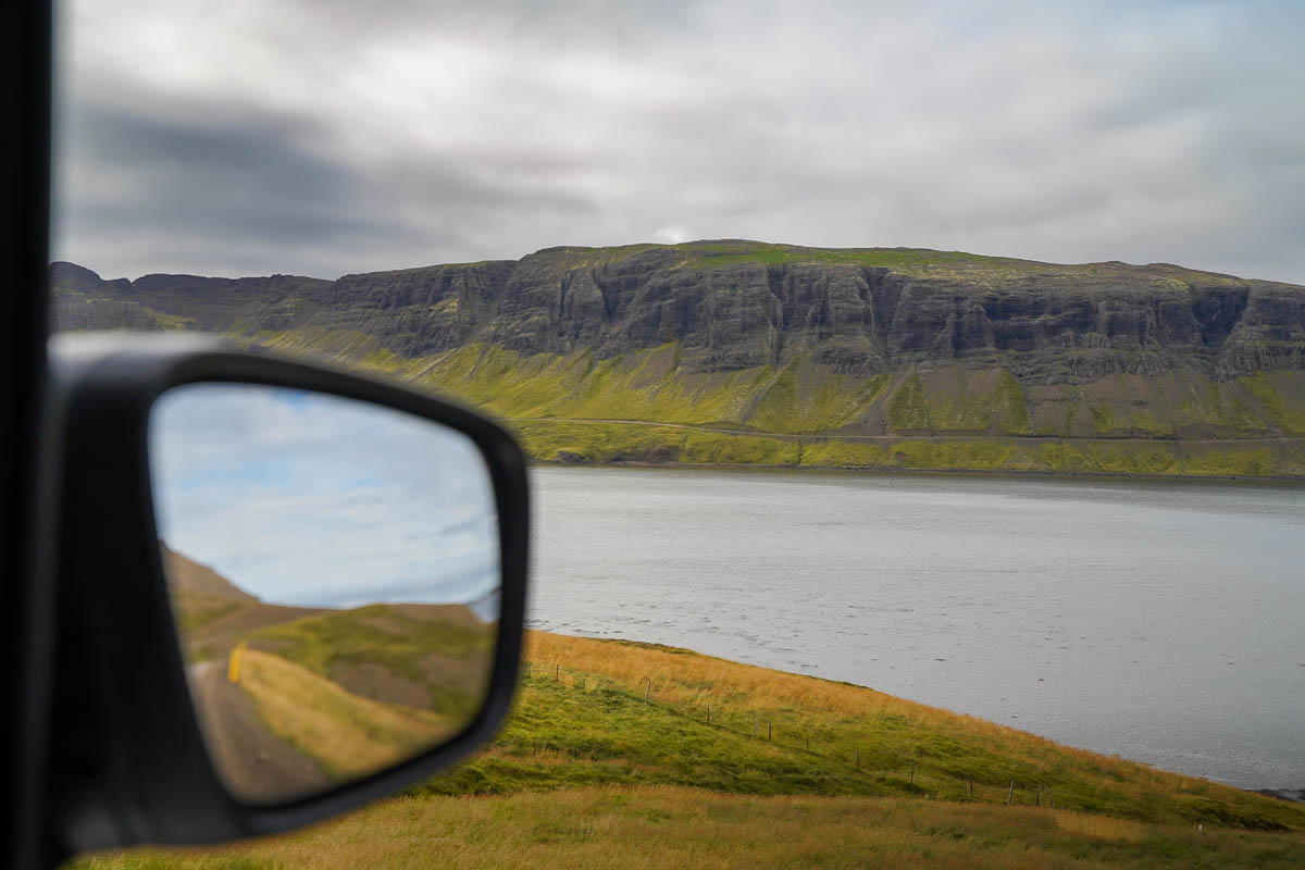 View out of a car window and side view mirror of a fjord in the Snæfellsnes Peninsula in Iceland
