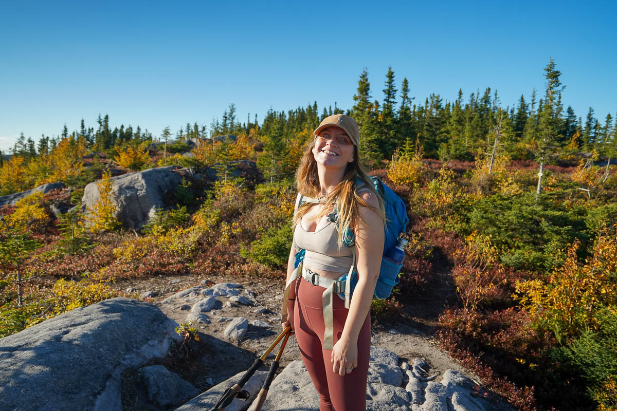 Woman standing at the summit of Mont de l'Original along the Mont du Dome hike in Quebec, Canada