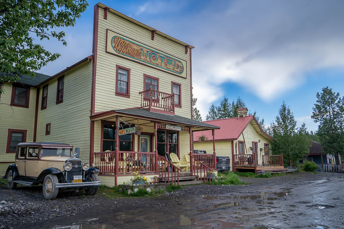 Ma Johnson's Hotel with a antique car parked next to it in McCarthy, Alaska