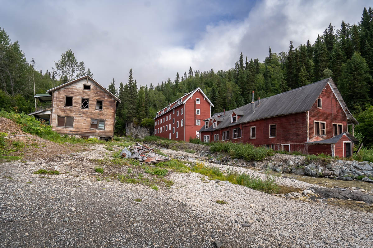 Rustic wooden buildings with pine trees in the background in the mining town of Kennicott in Wrangell-St. Elias National Park in Alaska