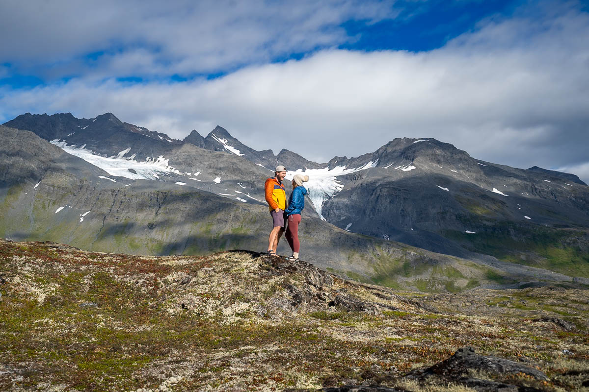 Couple standing on a mountain ridge at Thompson Pass near Valdez, Alaska