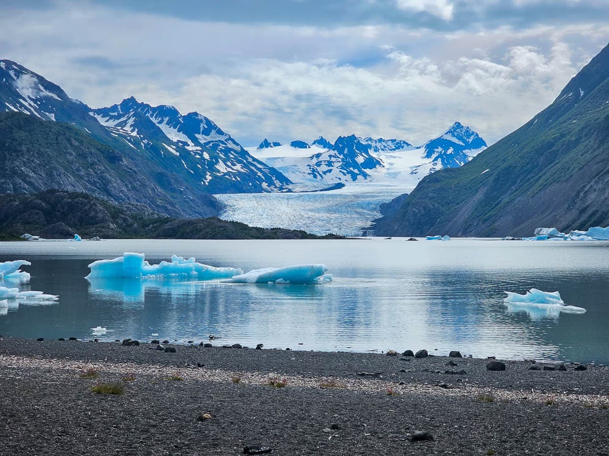 Icebergs in a glacial lake with the Grewingk Glacier and mountains in the background in Kachemak Bay State Park, Alaska