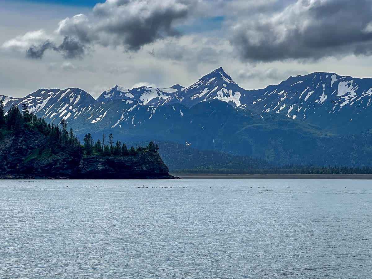 Snowcapped mountains and a rugged coastline in Kachemak Bay State Park, Alaska