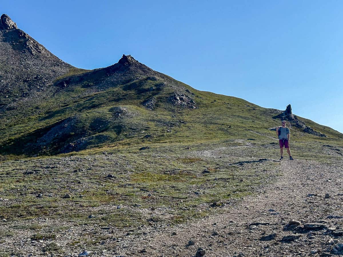 Man hiking along a rocky pathway along the Savage Alpine Trail in Denali National Park, Alaska