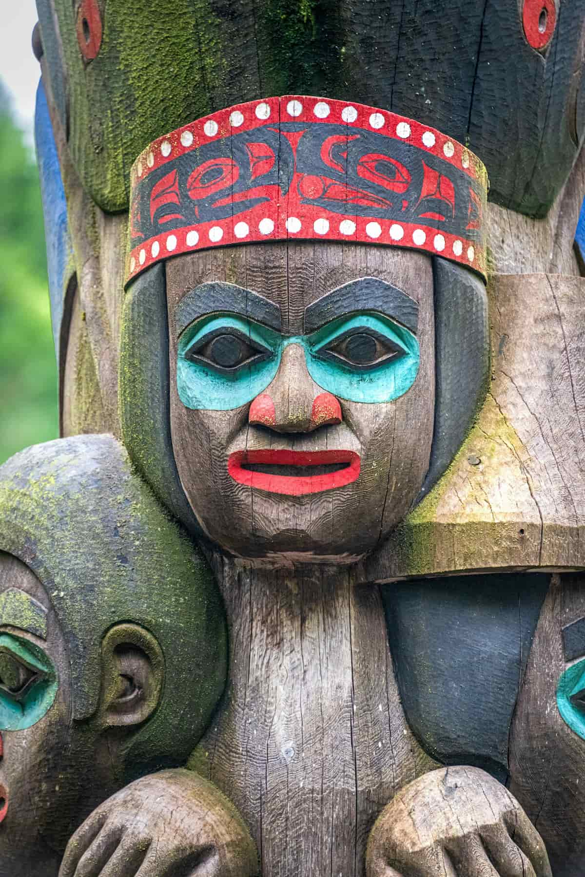 Painted face on a totem pole in Alaska