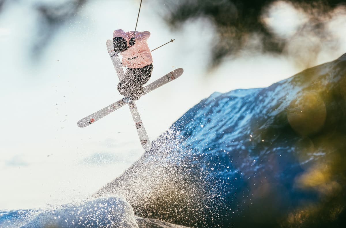 Woman jumping with skis at Alyeska Resort in Anchorage, Alaska