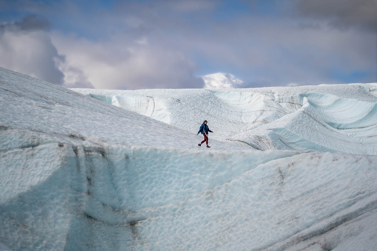 Woman walking on a ridge of the Root Glacier in Wrangell-St. Elias National Park in McCarthy, Alaska