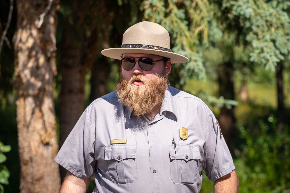 Ranger standing in front of pine trees in Denali National Park, Alaska