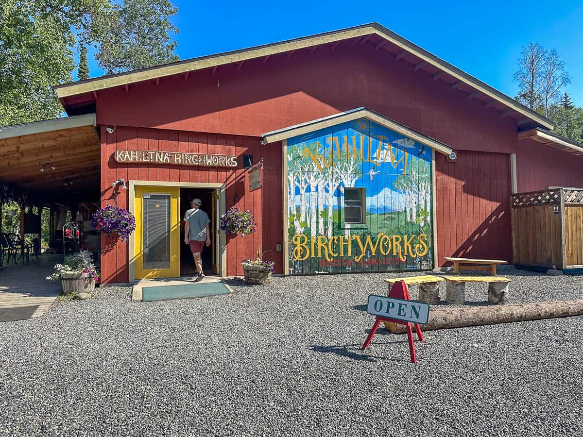 Man walking into Kahiltna Birchworks in Talkeetna, Alaska