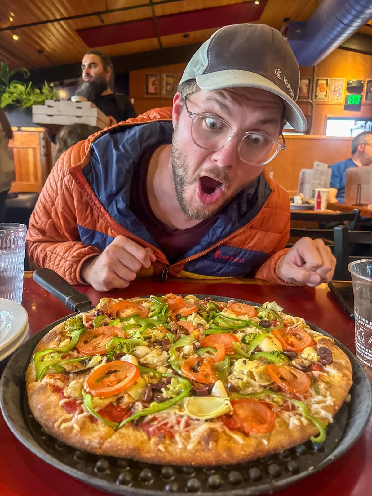 Man looking at pizza from Moose's Tooth Pub and Pizzeria in Anchorage, Alaska