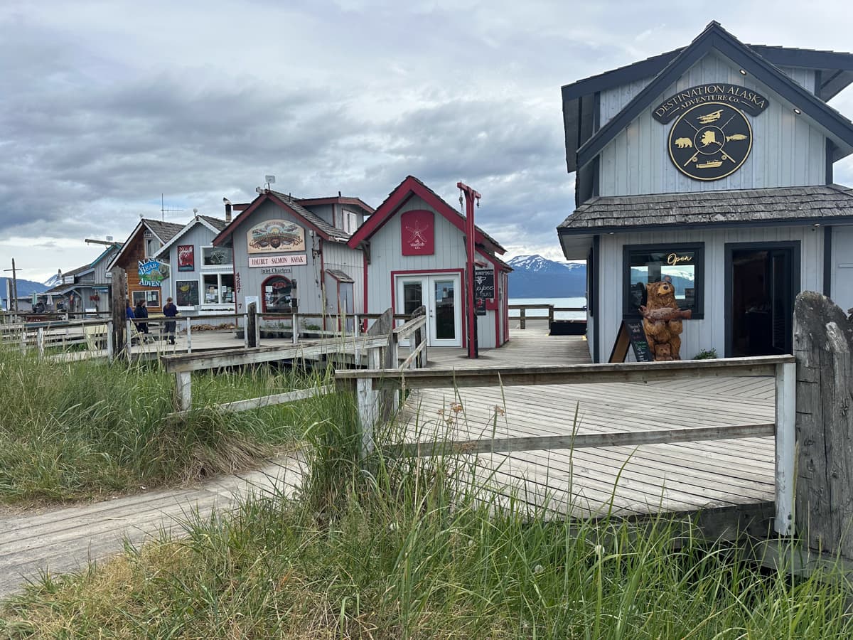 Buildings along the Homer Spit with the Kenai Mountains in the background in Homer, Alaska