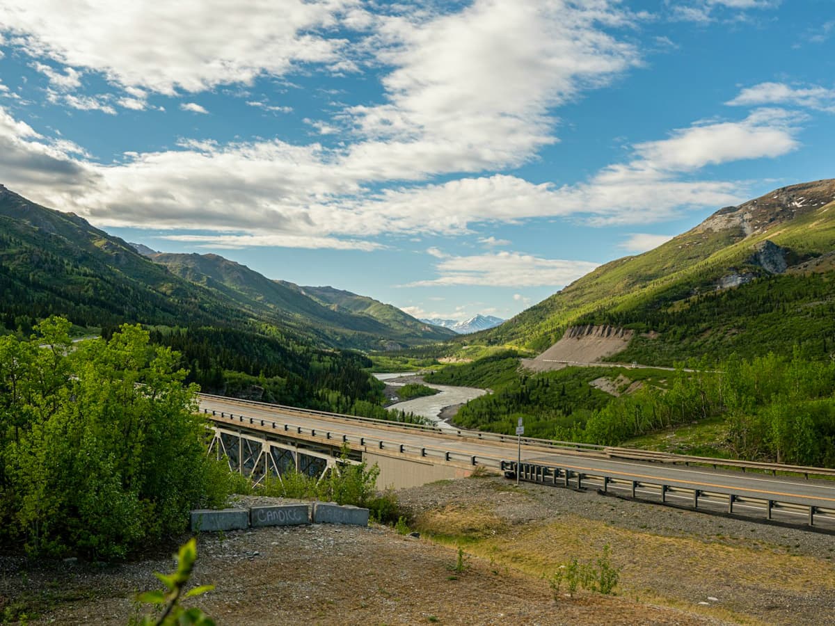 Bridge leading over the Nenana River surrounded by mountain slopes in Healy, Alaska