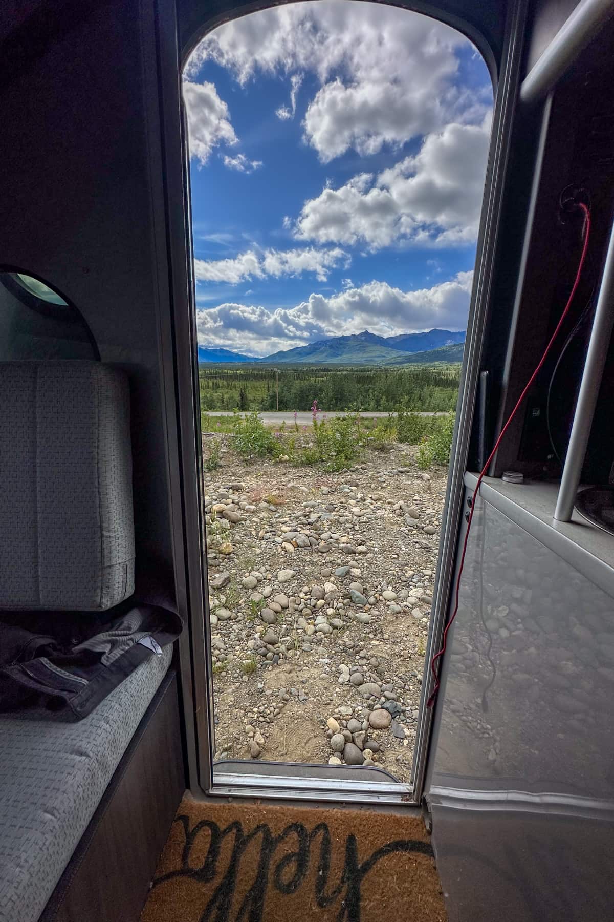 View out of a trailer door of the Alaska Mountain range while camping outside of Denali National Park in Alaska