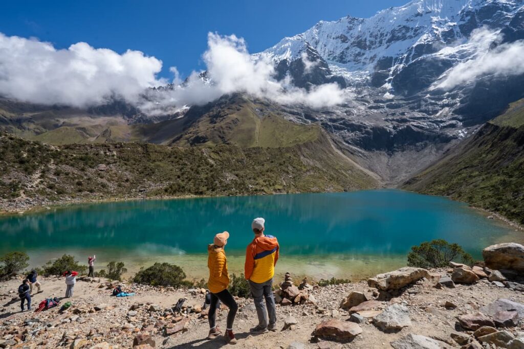 Couple standing next to Humantay Lake in the Andes Mountains of Peru