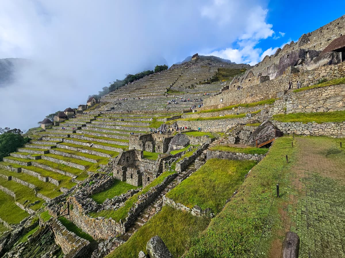 Agricultural terraces and building ruins along a steep hillside at Machu Picchu, Peru