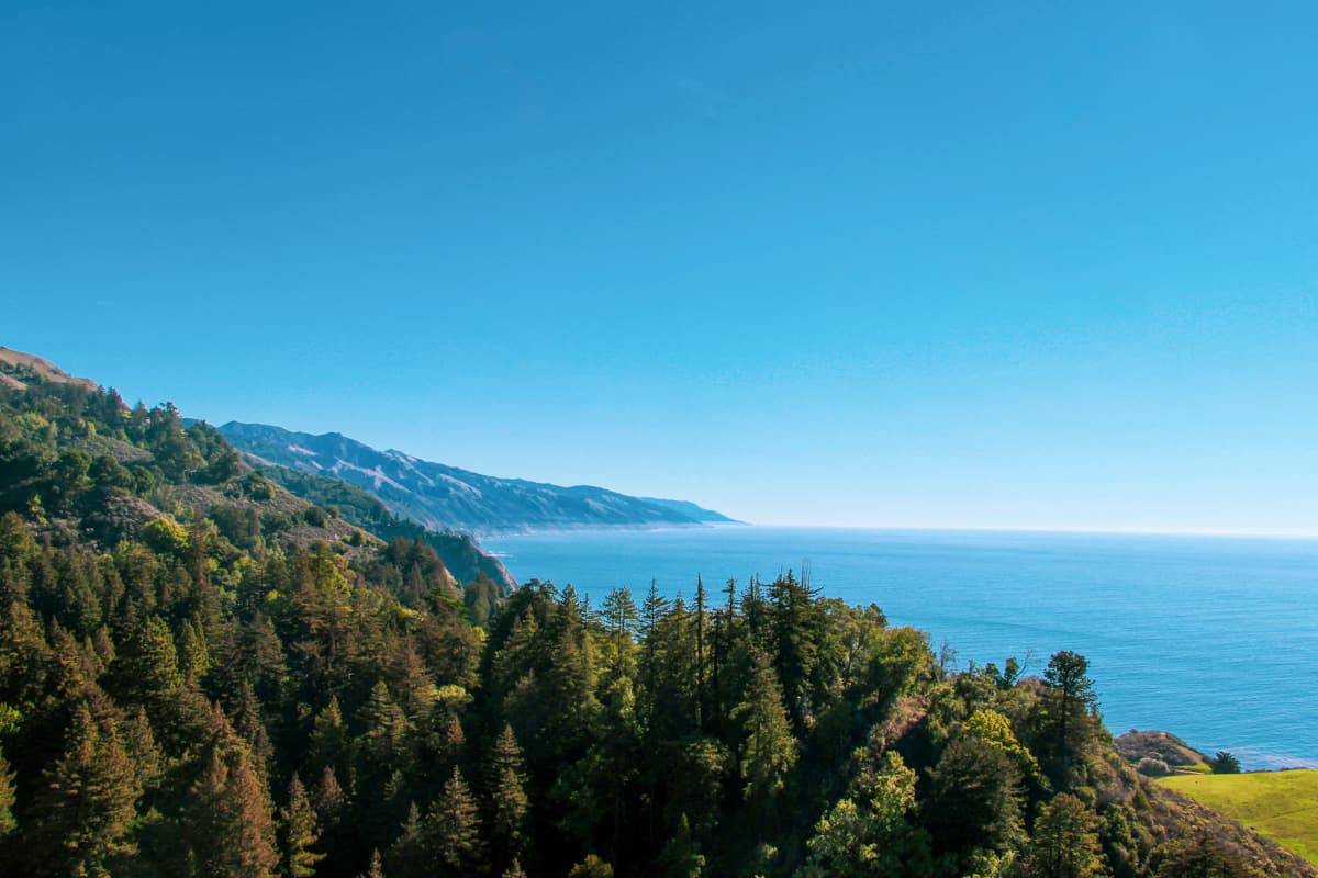 View of cliffsides with Pacific Ocean from Nepenthe Restaurant in Big Sur, California
