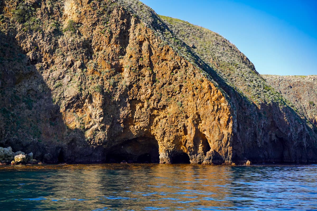 Sea caves on a cliffside in Santa Cruz Island in Channel Islands National Park in California