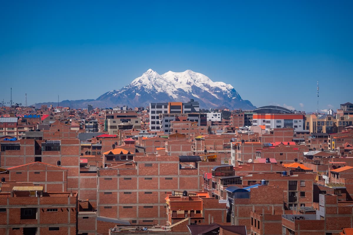 Snow-capped Mount Illimani with colorful buildings in the foreground in La Paz, Bolivia