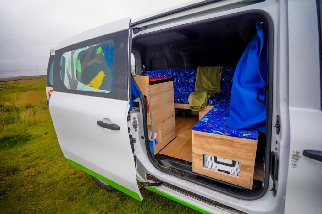 View of the storage and couch in a Happy 1 campervan model from Happy Campers in Iceland