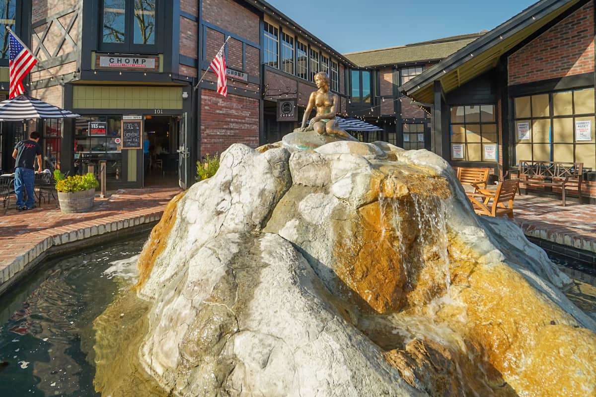 Little Mermaid statue on top of a rock in a fountain in Solvang, California