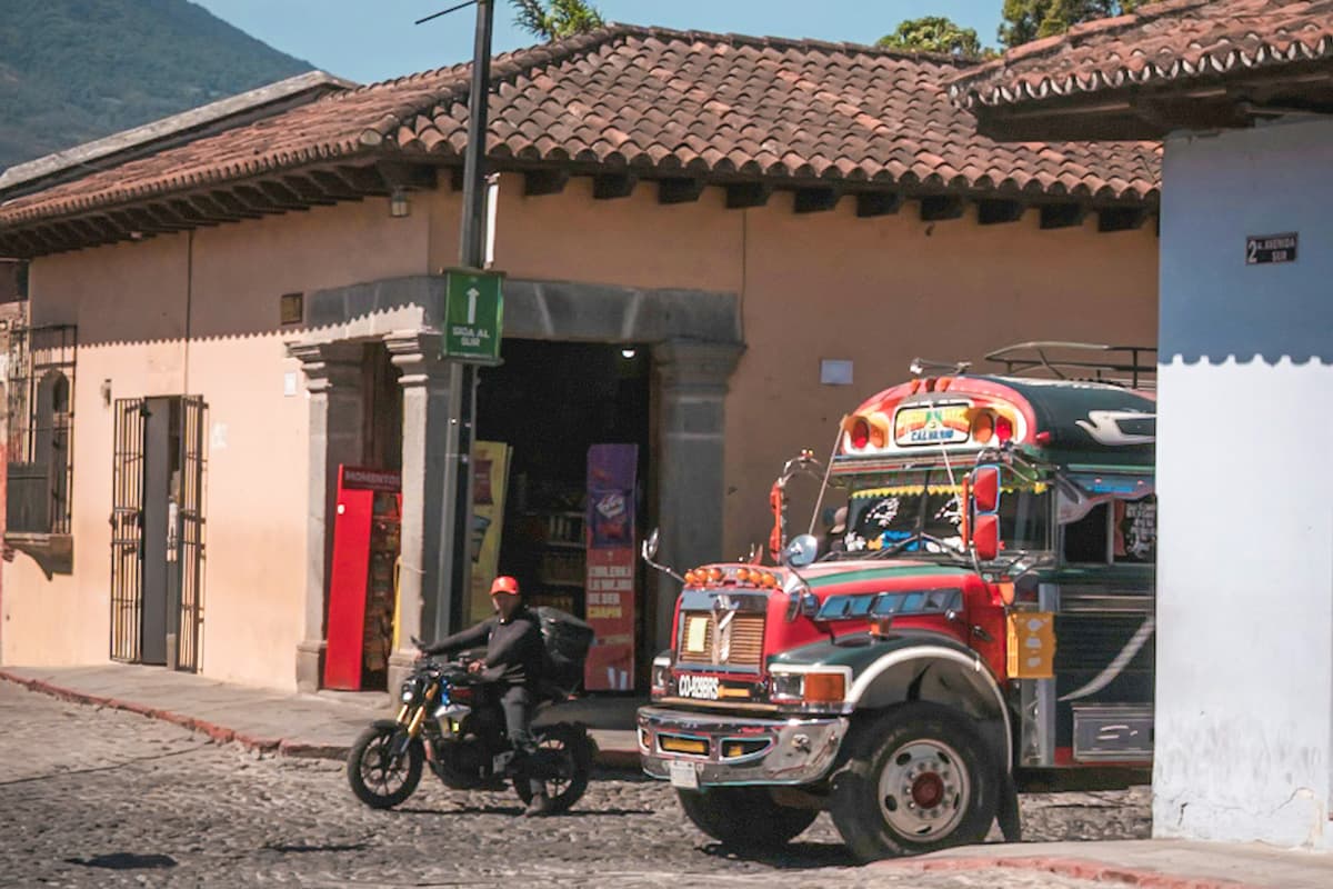 Chicken bus driving down a cobblestone street in Antigua, Guatemala
