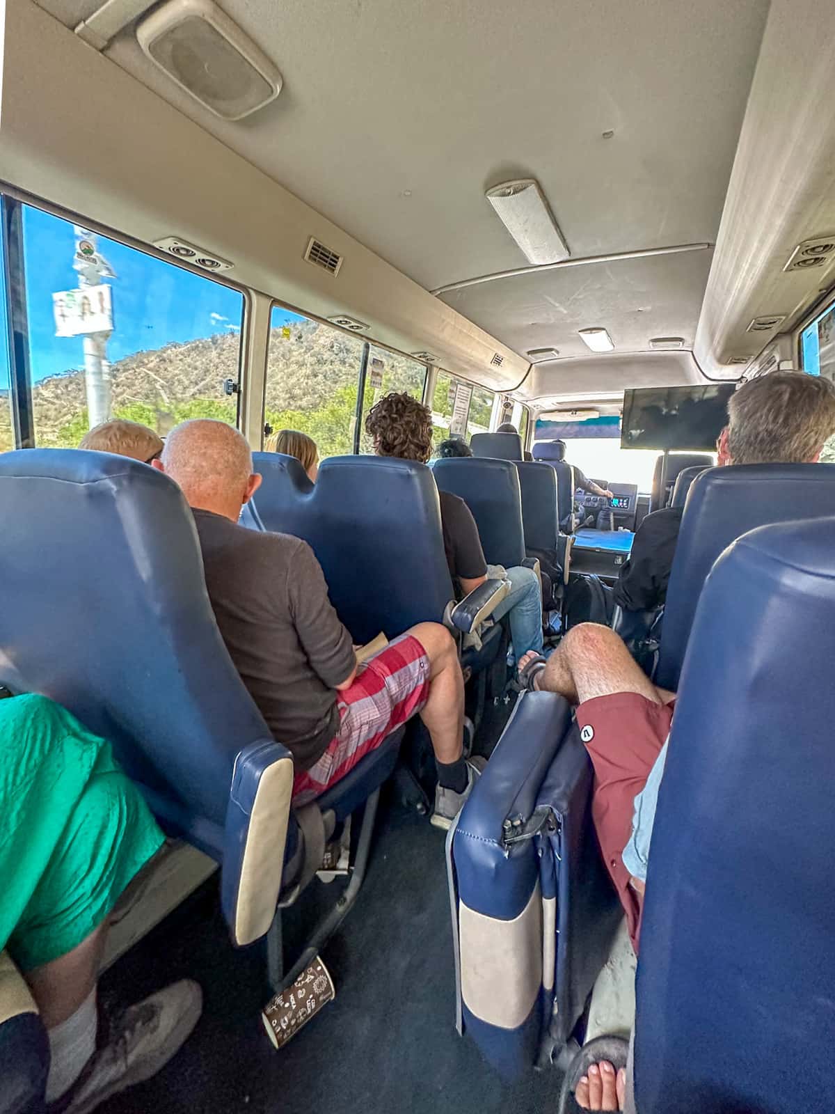 Travelers sitting on a shuttle bus heading from Antigua to Lake Atitlan, Guatemala