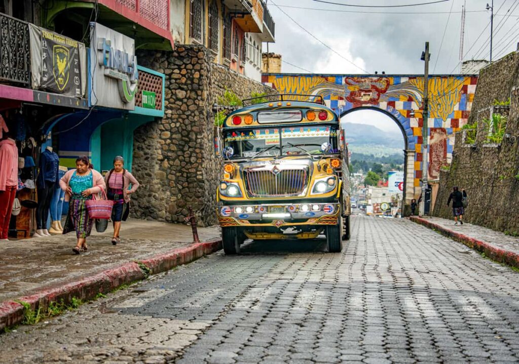 Chicken bus driving down a cobblestone street in Panajachel, Lake Atitlan, Guatemala